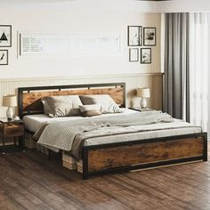 a large bed sitting on top of a hard wood floor next to a wooden table