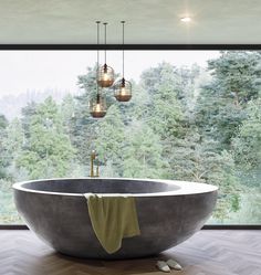 a large bathtub sitting in the middle of a room next to a window with lots of trees