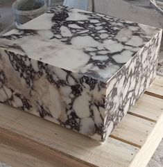 a marble box sitting on top of a wooden pallet