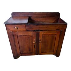 an old wooden cabinet with two doors and drawers