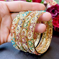 gold plated silver bangles in Navaratna colors Navratan Bangles, Jadau Bangles, Hyderabadi Jewellery, Mughal Jewelry, Hyderabadi Jewelry, Jewellery Bangles, Jadau Jewellery, Rajputi Jewellery, Bridal Jewelery