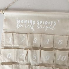 a white sign hanging on the side of a wall next to a string with numbers