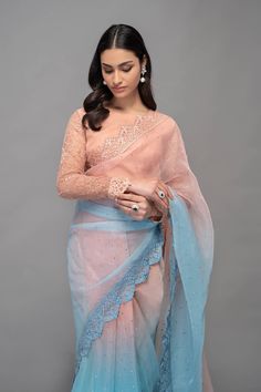 a woman in a blue and pink sari