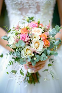 a bride holding a bouquet of flowers in her hands