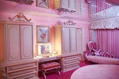 a bedroom with pink walls and furniture in the room is decorated like a princess's castle