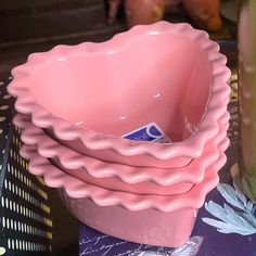 three pink bowls sitting next to each other on a table