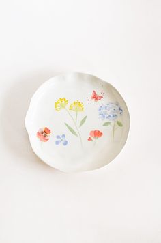 a white plate with flowers painted on it