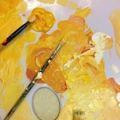 the paint is being mixed in with brushes and other art supplies to create an abstract painting