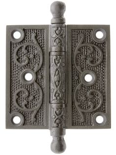 an iron door hinge with decorative designs on the front and back sides, set against a white background