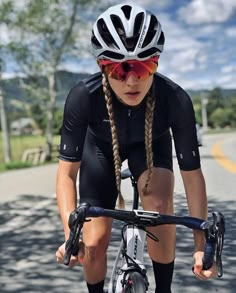 a man riding a bike down a street