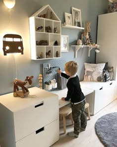 a little boy playing with toys in his room