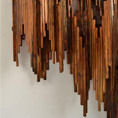 a large wooden sculpture hanging from the side of a wall