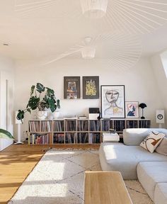 a living room filled with furniture and lots of books