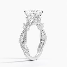 a white gold engagement ring with an intricate twist design on the band and side stones