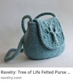 a small blue purse sitting on top of a white table