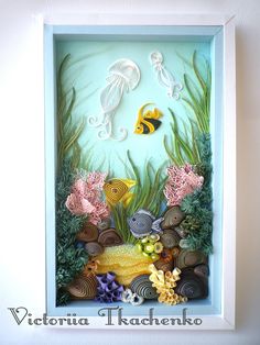 an underwater scene made out of seaweed, rocks and seashells in a shadow box