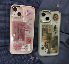 two cell phones with stickers on them sitting next to each other in the same case