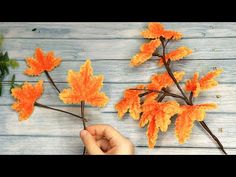 someone is making fake leaves out of yarn