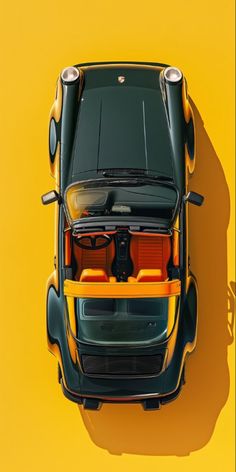 an overhead view of a yellow sports car with its hood open and seats folded down