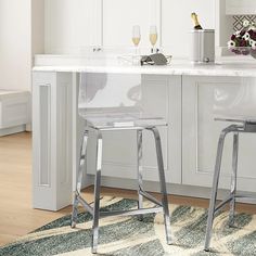 two clear stools in front of a kitchen island