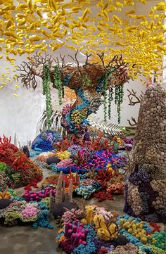 a room filled with lots of fake corals and other colorful items hanging from the ceiling