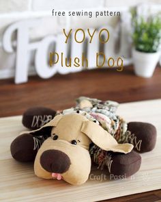 a stuffed dog laying on top of a wooden table