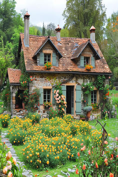 Rustic cottage with colorful garden in full bloom in a French garden. Cottage Home With Garden, Cozy Home Garden, Cottage Garden Photos, Cottage House Designs Exterior, Cottage Home Garden, Cozy Cottage Home Exterior, English Cottage With Garden, Whimsical Cottage Exterior, Cozy Cottage Garden