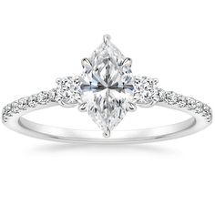 a white gold engagement ring with an oval cut diamond and pave set diamonds on the band