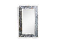 a large mirror hanging on the wall next to a white wall with an old metal frame