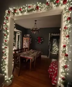 a dining room decorated for christmas with lights