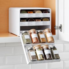 an open spice rack with spices in it