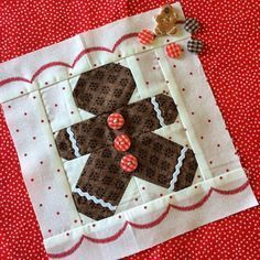 a close up of a piece of fabric on a red table cloth with white polka dots