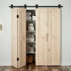 an open wooden cabinet in a room with white walls and wood flooring on the side