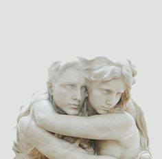 two white marble statues hugging each other