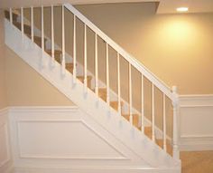 an empty room with stairs and carpeted floor