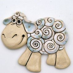 a ceramic sheep ornament with spirals on it