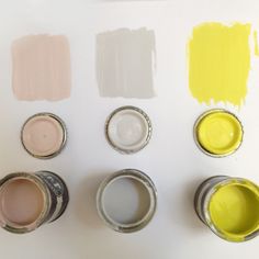 paint cans with different shades of yellow and white