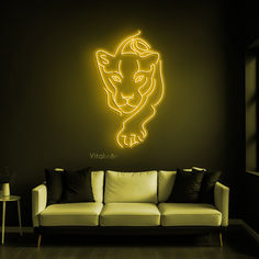 a living room with a white couch and a neon lion wall decal on the wall