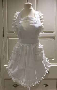 a white dress with ruffles is on display