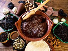 a wooden table topped with lots of different types of desserts and confections