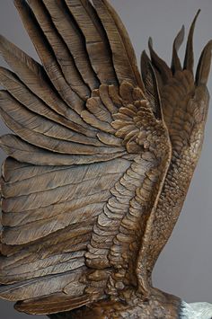 a statue of an eagle with its wings spread out and it's head turned to the side