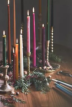 a table topped with lots of candles next to scissors and other items on top of it