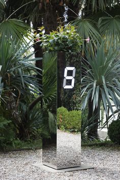 the number eight is displayed in front of some plants