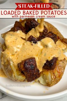 loaded baked potatoes with parmesan cream sauce on a white plate and text overlay reads steak - filled loaded potatoes with parmesan cream sauce