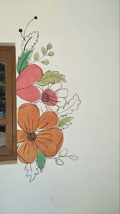 a painted flower on the side of a wall next to a window with a mirror