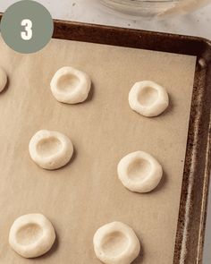 doughnut holes on a baking sheet ready to go into the oven for making cookies