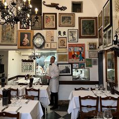 a man is standing in the middle of a restaurant