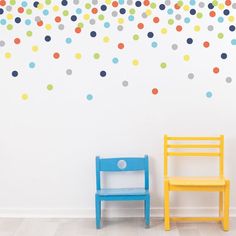 two children's chairs in front of a polka dot wall decal on a white wall