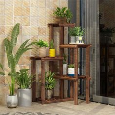 three wooden shelves with plants on them in front of a door