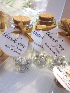 small jars filled with cookies sitting on top of a table